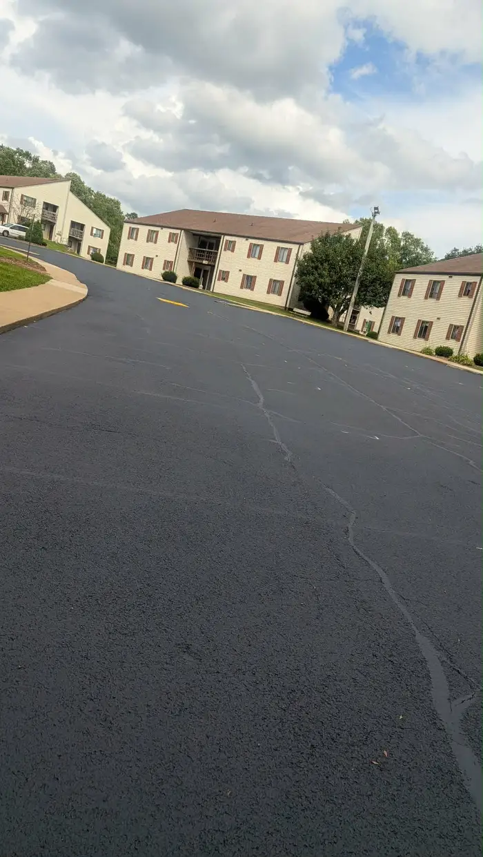 Large apartment complex lot covered in fresh sealcoat, before the new lines go down