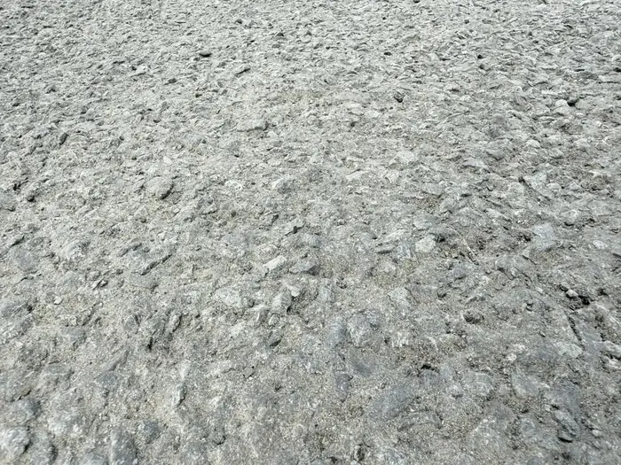 Close up of a finished tar and chip surface showing stone bedded into the binder